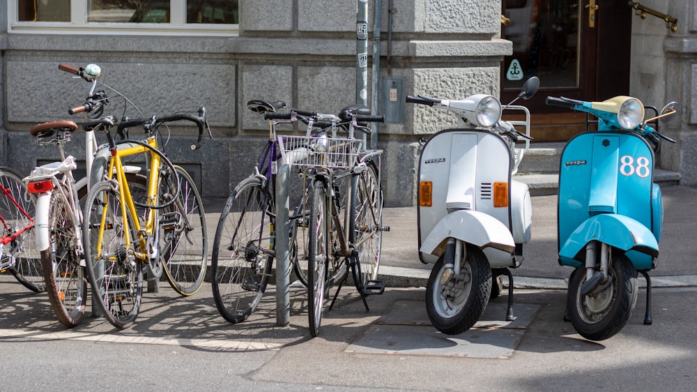 white and black city bike parked beside gray metal fence during daytime