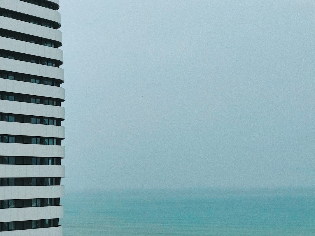 white and black concrete building near sea during daytime