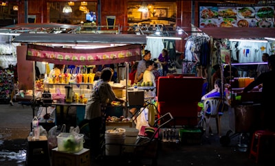 A chilled glass of Qingdao beer beside a bustling night market stall.