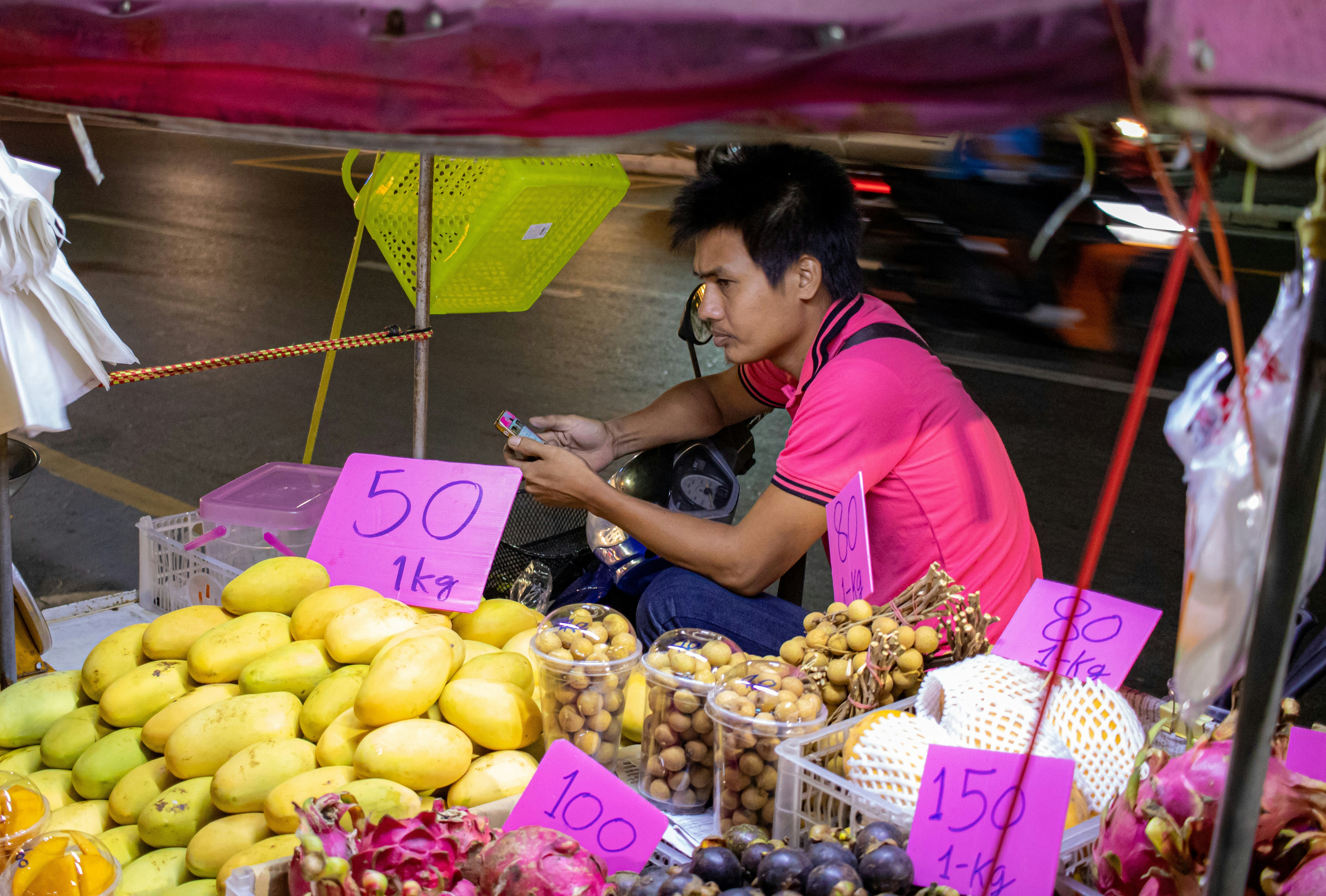 A boy selling fruits at roadside in Phuket, Thailand