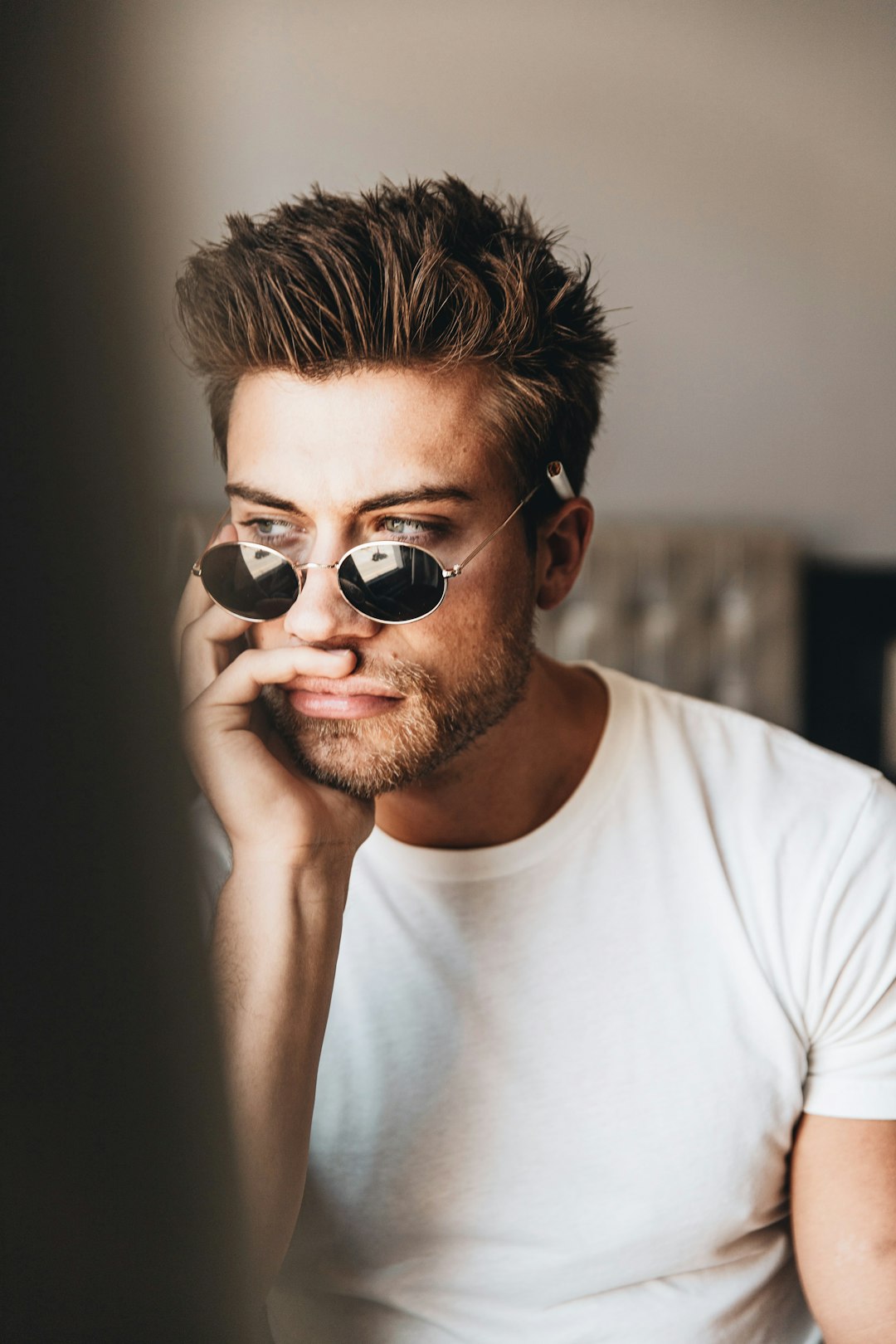 man in white crew neck shirt wearing black sunglasses