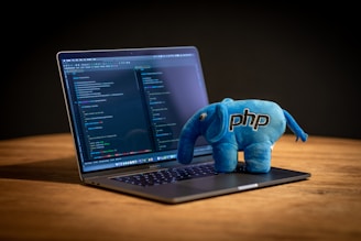 blue elephant plush toy on black laptop computer