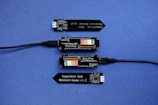 Digital sensors connected to a water sample for real-time analysis.