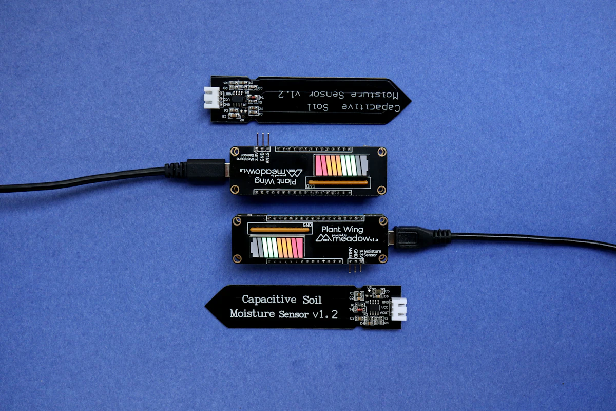 Three electronic components sitting on top of a blue surface