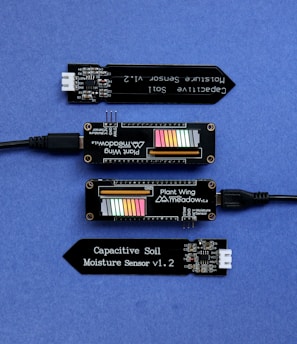 three electronic components sitting on top of a blue surface