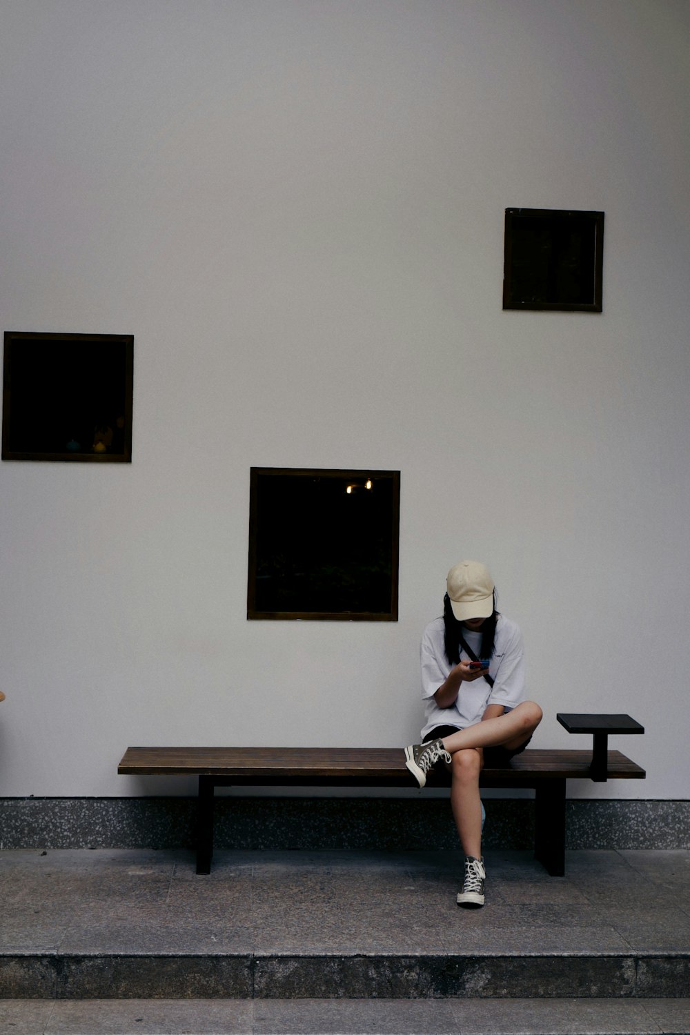 man in blue t-shirt and black shorts sitting on black bench