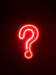 red neon question mark on wall