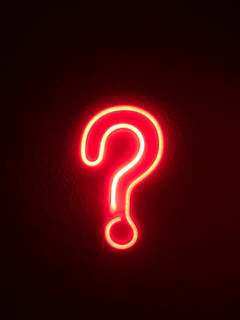 red neon question mark on wall