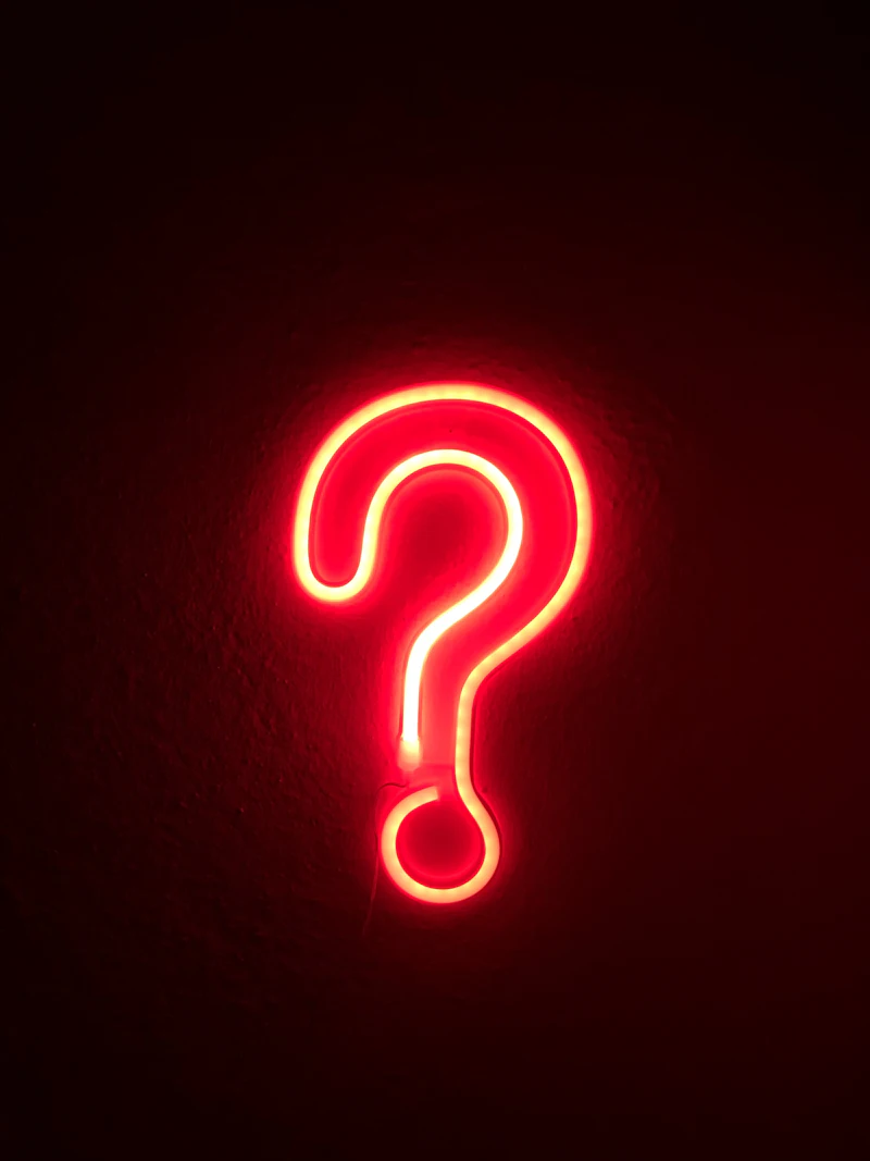 Illuminated lightbulb against dark background
