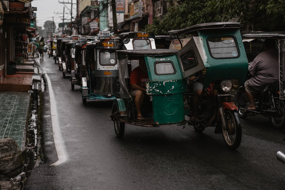 green and black auto rickshaw on road during daytime