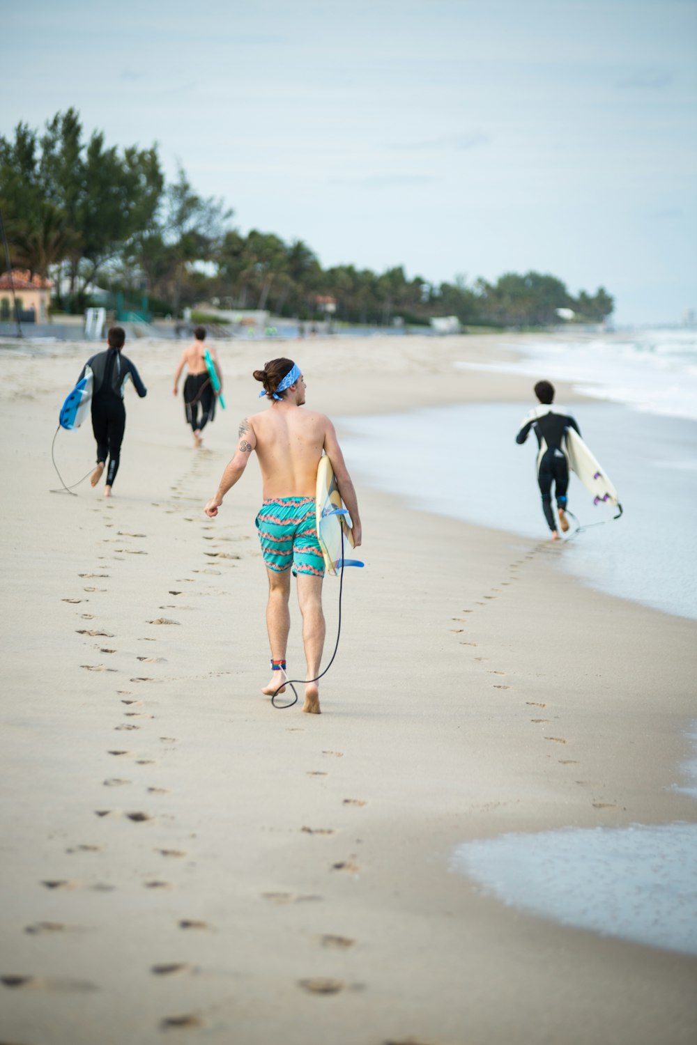 man in black jacket walking on beach during daytime