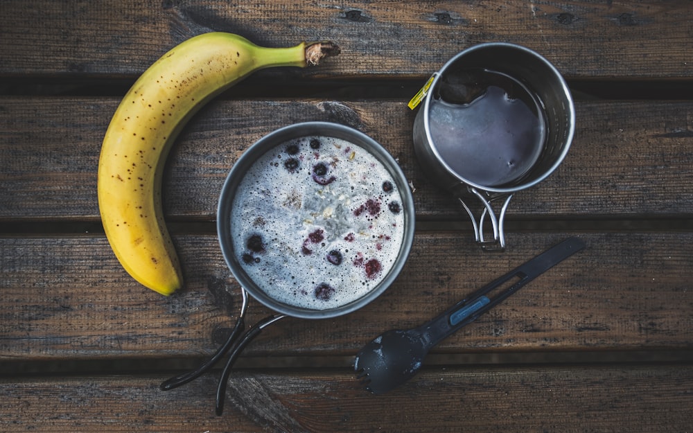 yellow banana fruit beside black cooking pot