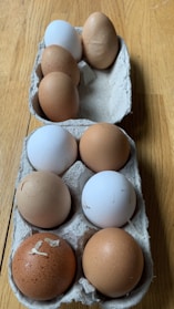 Carton of a dozen fresh eggs on a kitchen counter with natural light