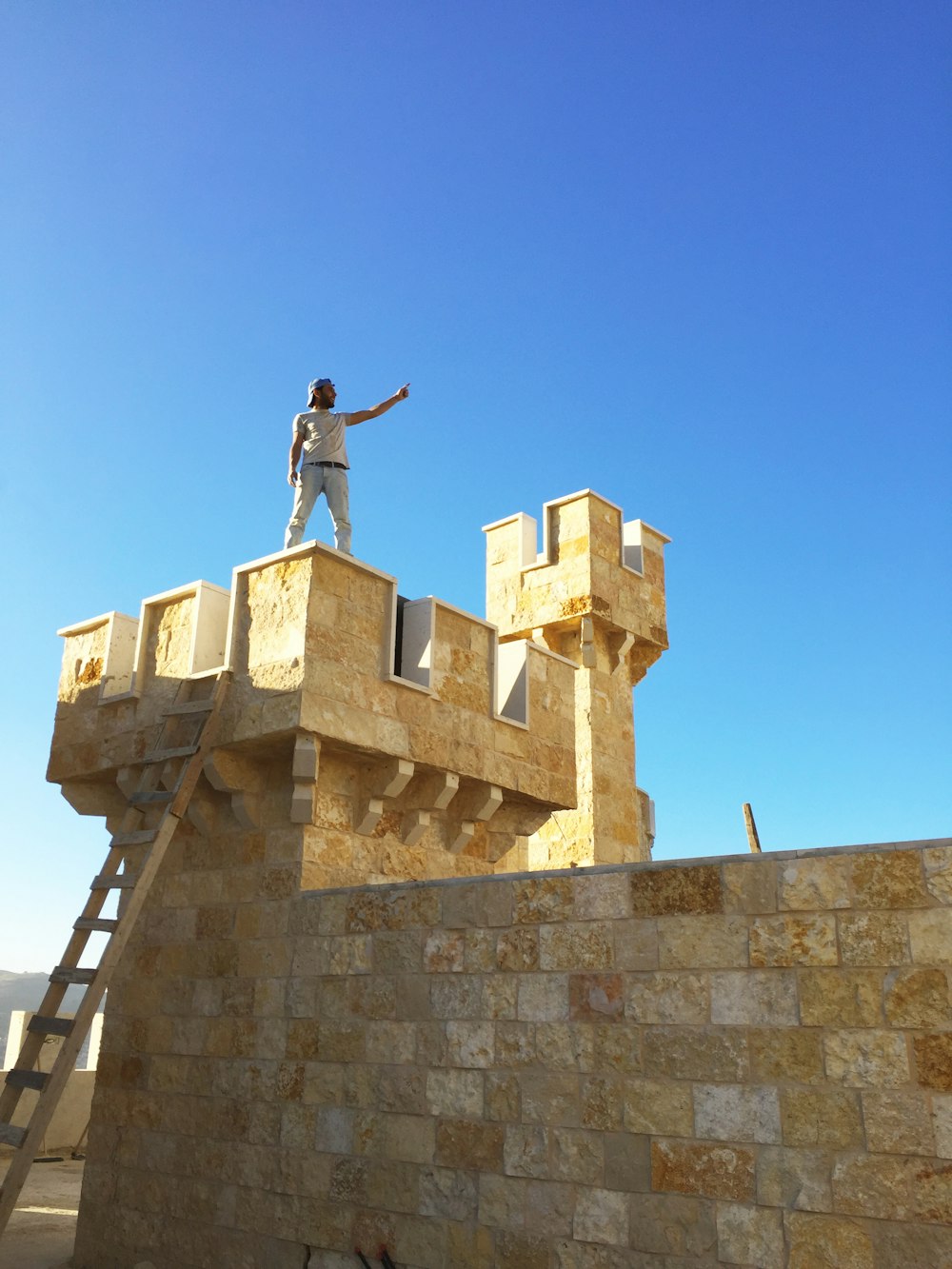 man in black jacket standing on top of building