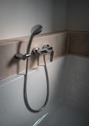 a close up of a bathtub with a shower head