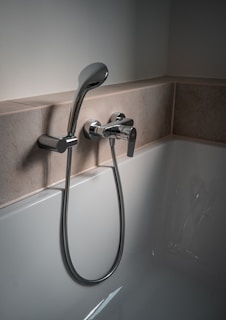 a close up of a bathtub with a shower head