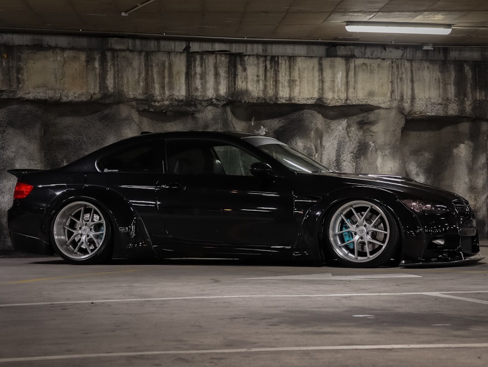 black porsche 911 parked on gray concrete road