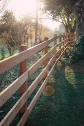 brown wooden fence on green grass field