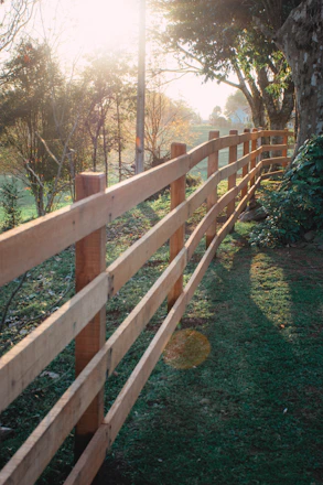 brown wooden fence on green grass field