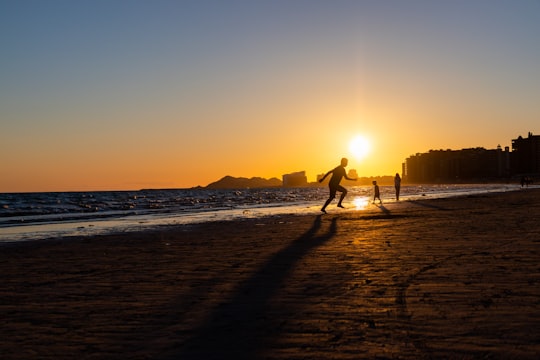 silhouette of man and woman walking on beach during sunset in Rocky Point Mexico