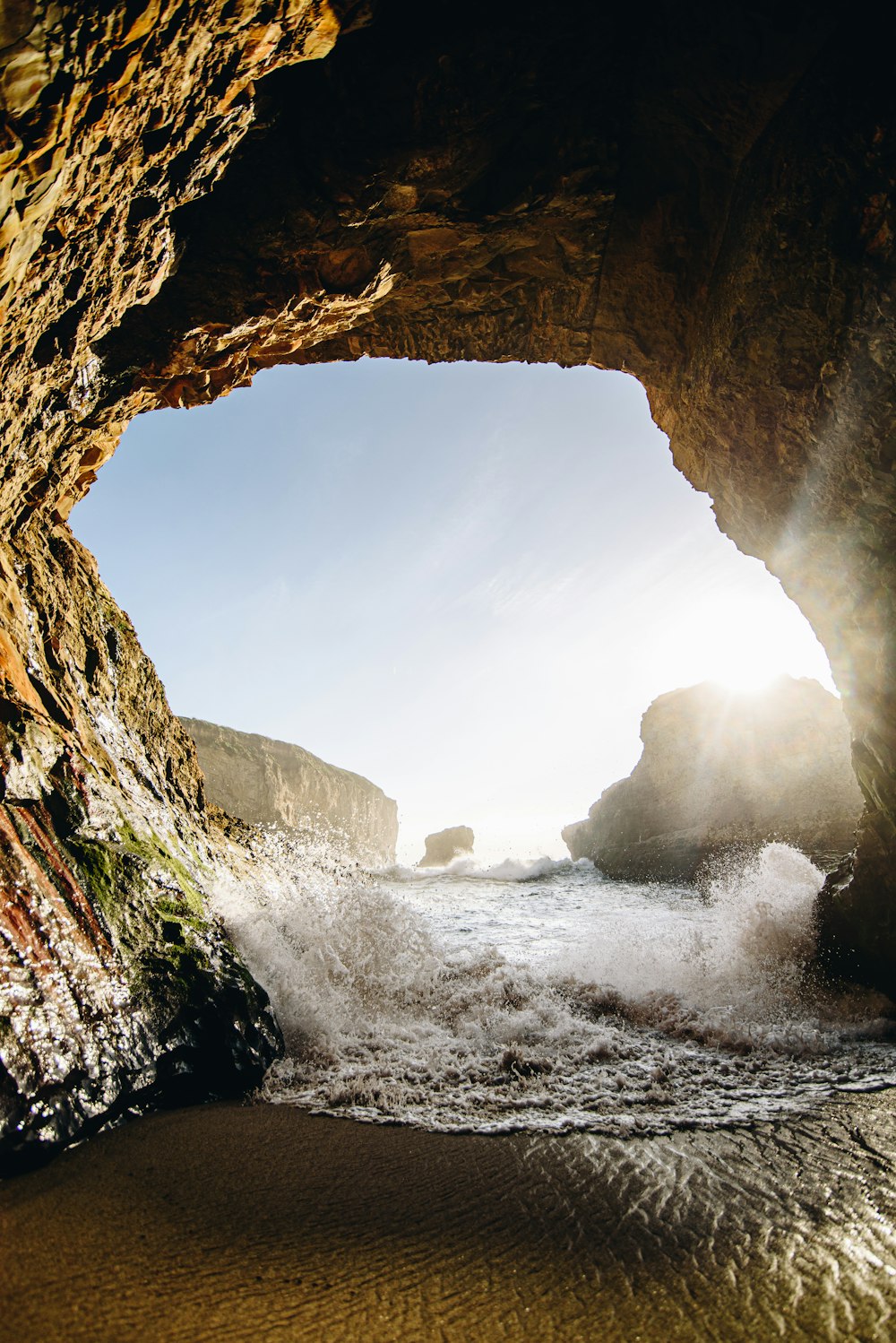 brown cave with water falls