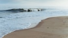 ocean waves crashing on shore during daytime