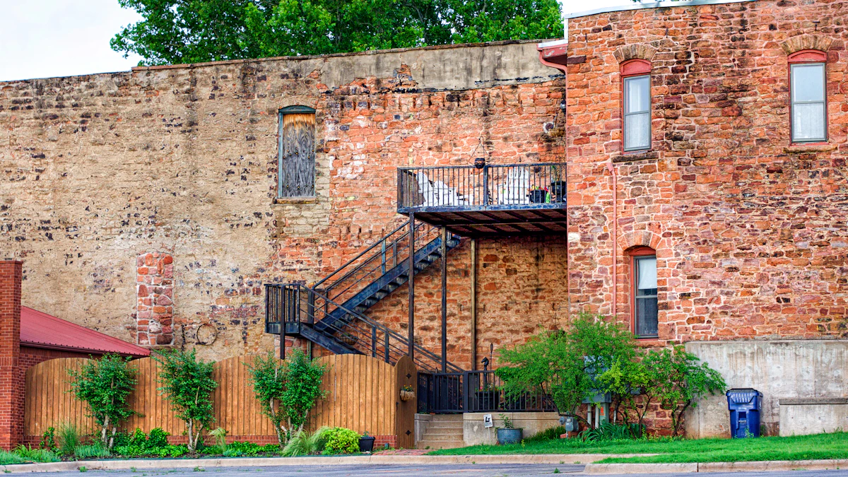 The back of an old brick and stone building with a metal staircase in Guthrie, Oklahoma