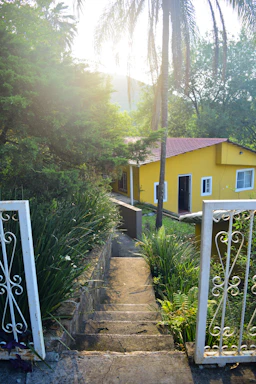 A welcoming front entrance of Golden Years Haven with soft greenery and warm sunlight.