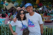 A joyful family enjoying a Disney theme park with smiles and laughter.