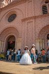 people standing in front of brown concrete building during daytime