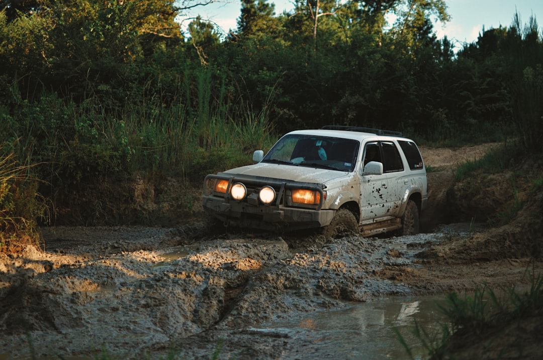 white suv on brown dirt road