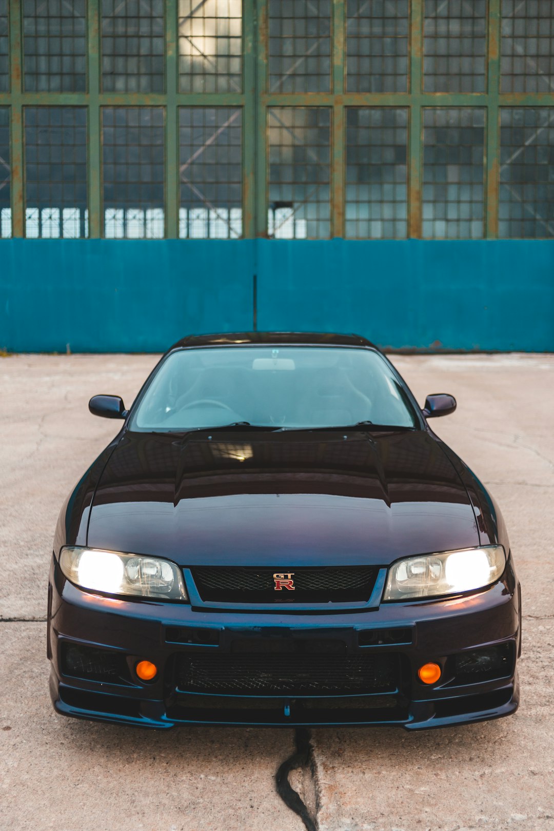 black chevrolet car parked near blue building