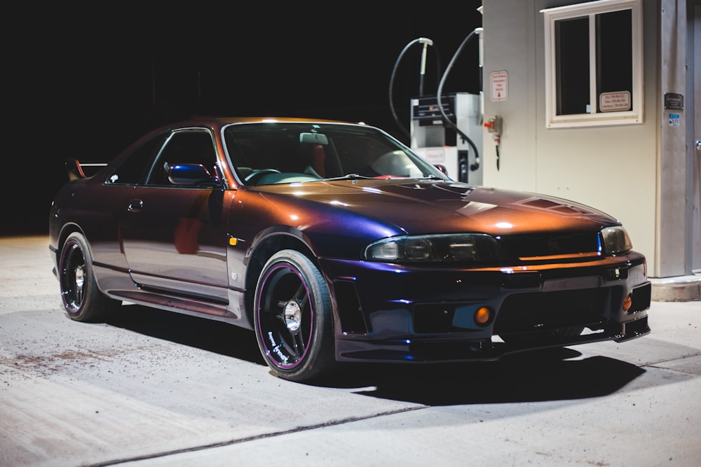 black bmw m 3 coupe parked in front of white building