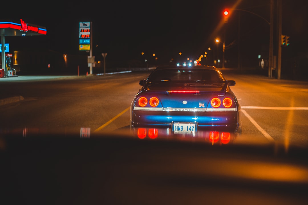 red bmw car on road during night time