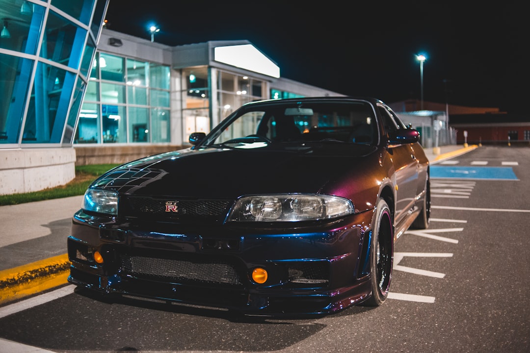 black bmw m 3 parked on parking lot during night time