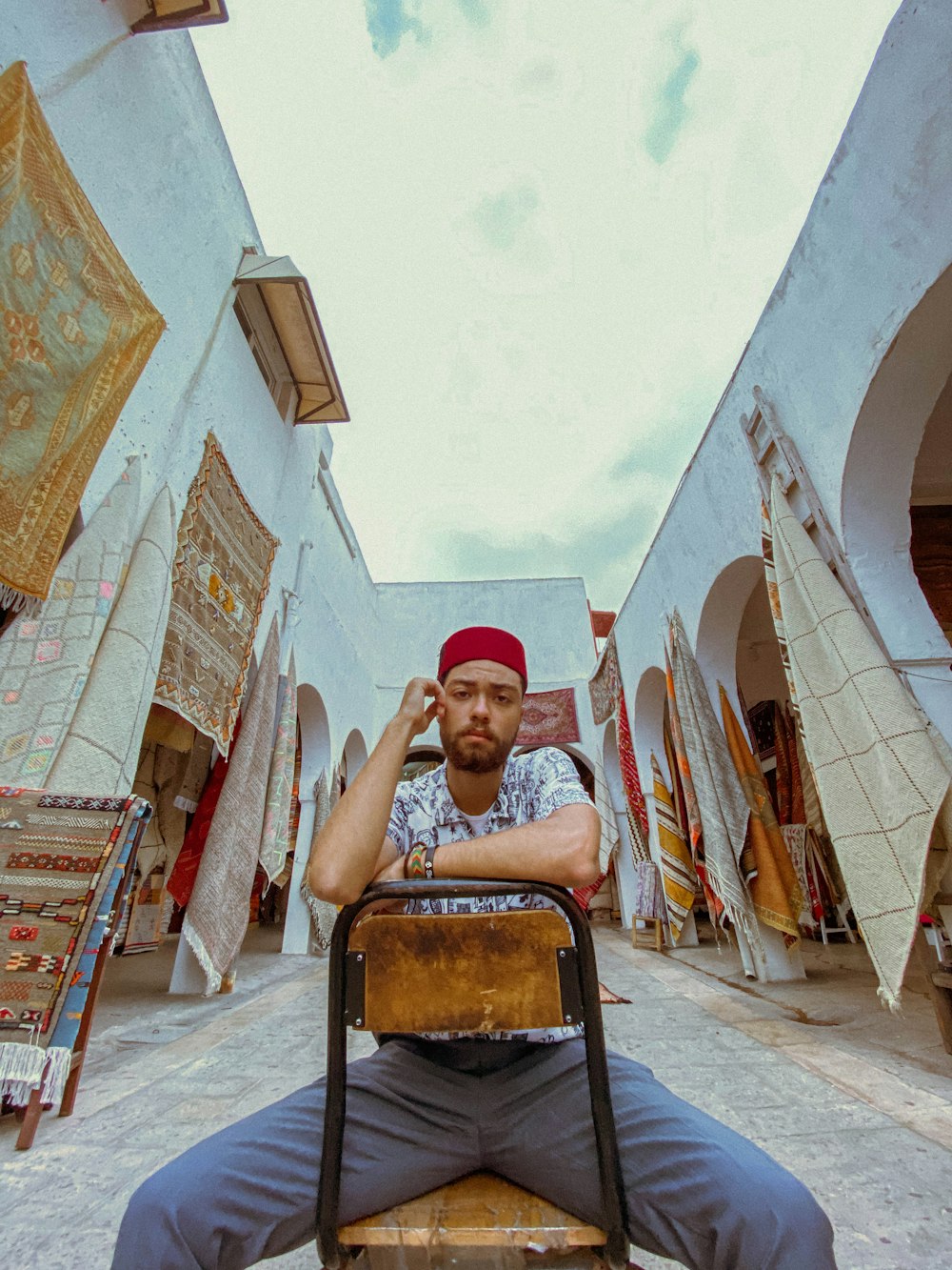 man in red cap sitting on black chair