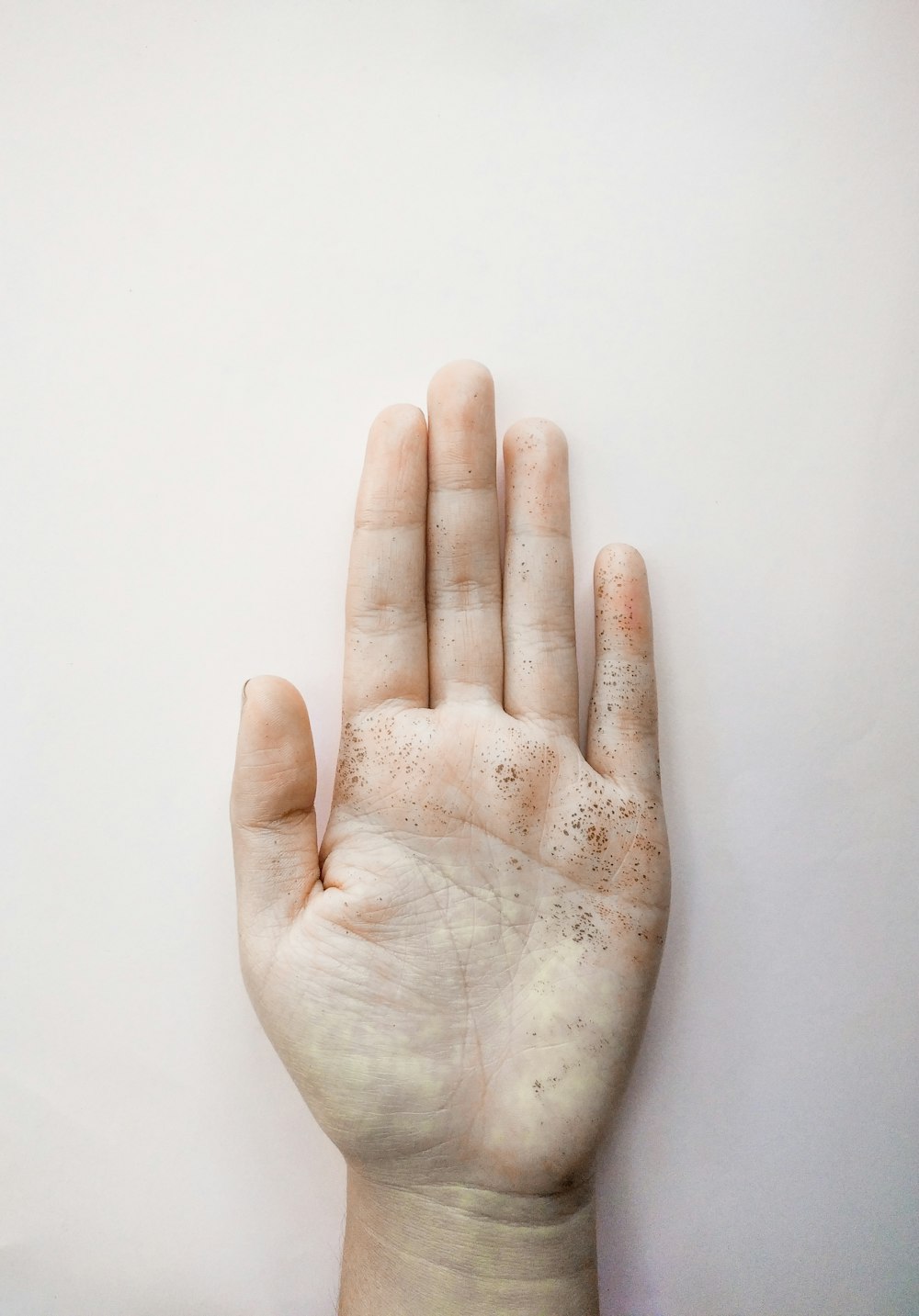 persons right hand on white surface