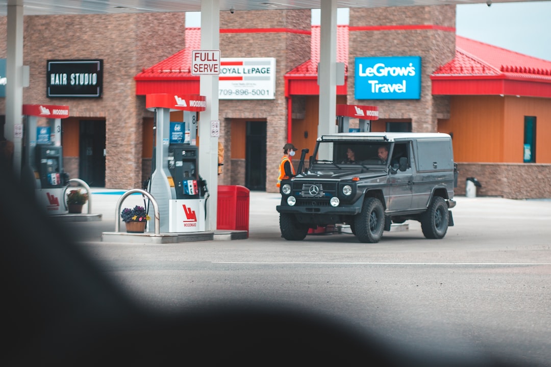 black jeep wrangler parked near red and white building during daytime