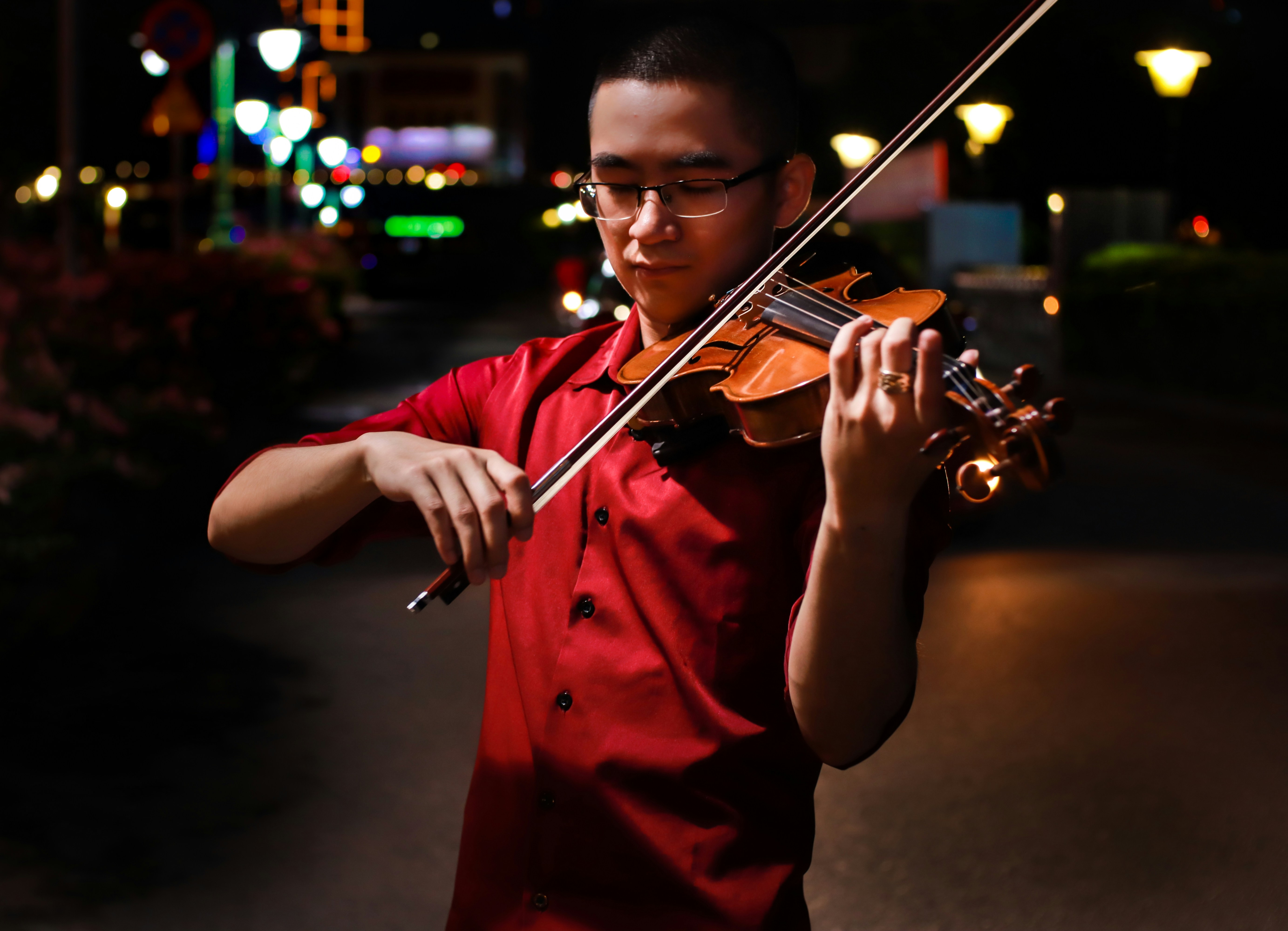 A smiling student holding a violin case.