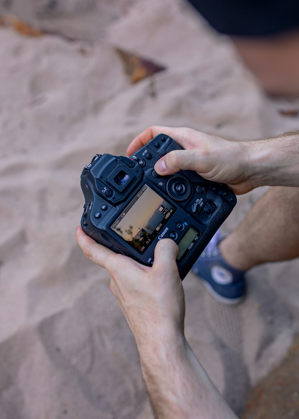 person holding black dslr camera