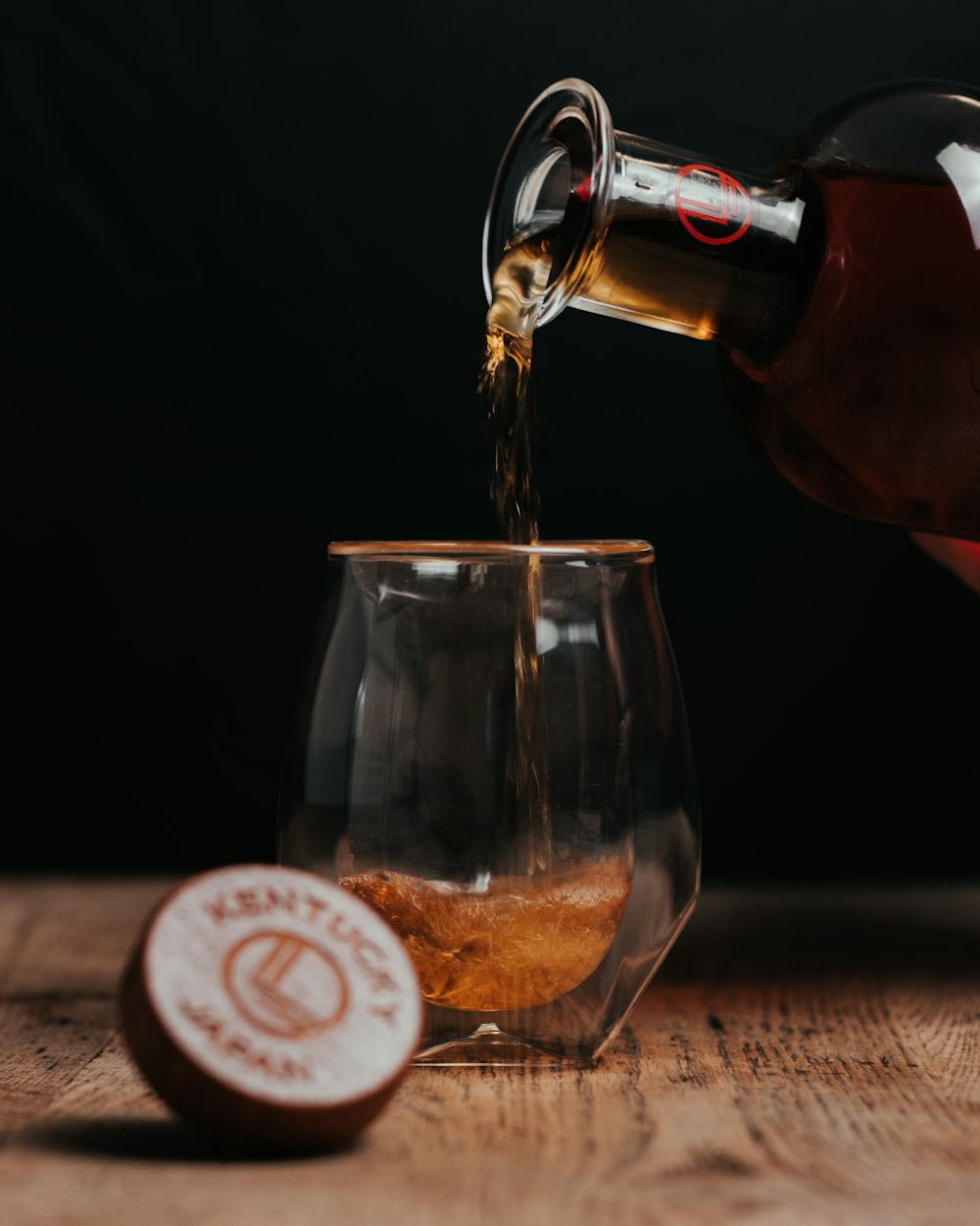 clear drinking glass with brown liquid