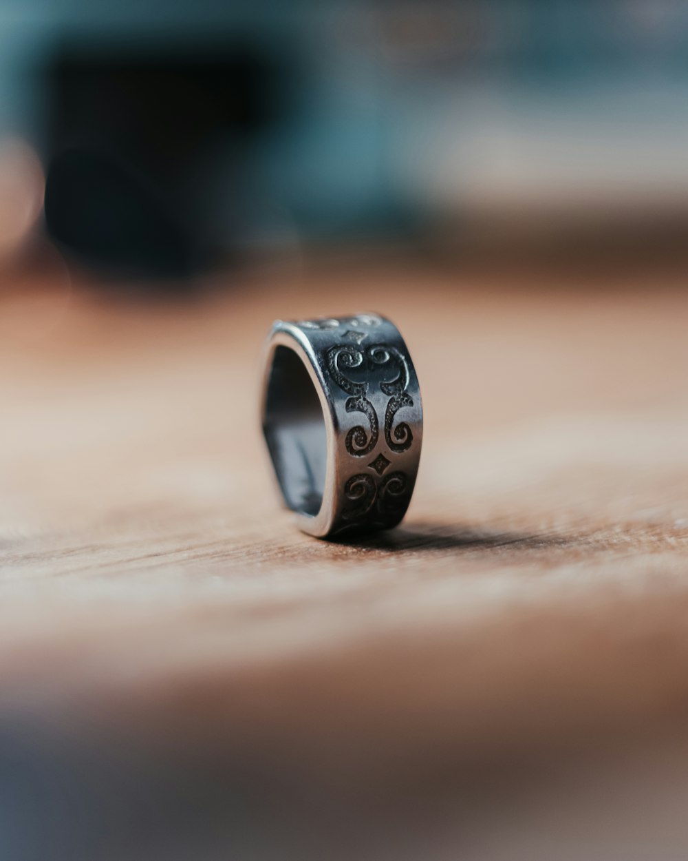 silver and black ring on brown wooden table