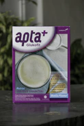 A box featuring a health-related product labeled 'apta+ Glukofit' with a purple and white design. The product claims a vanilla flavor and highlights benefits for diabetes, including low sodium and lactose content, high fiber, vitamins, and calcium. The front design includes a photo of a white beverage to suggest consumption.