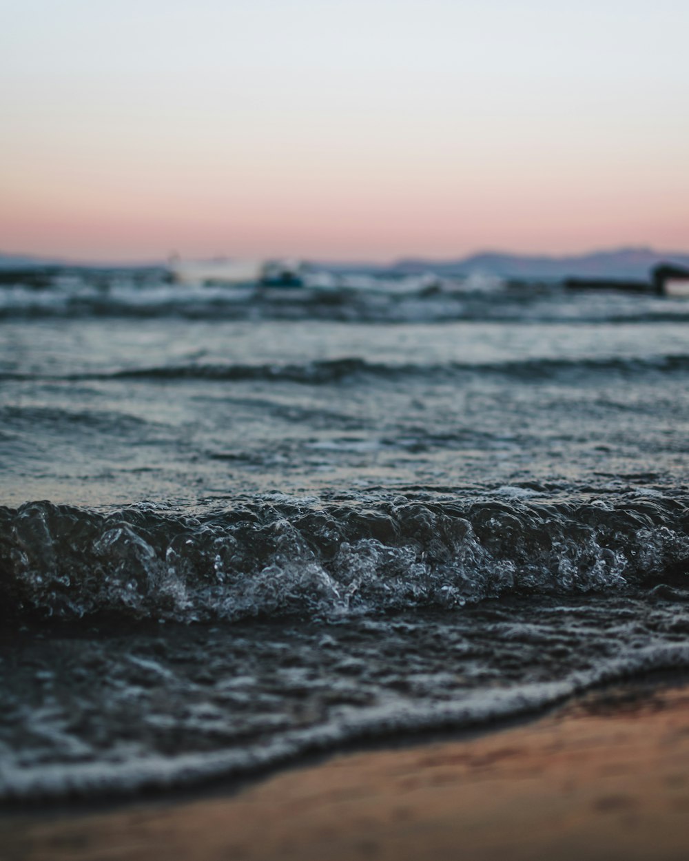 ocean waves crashing on shore during daytime