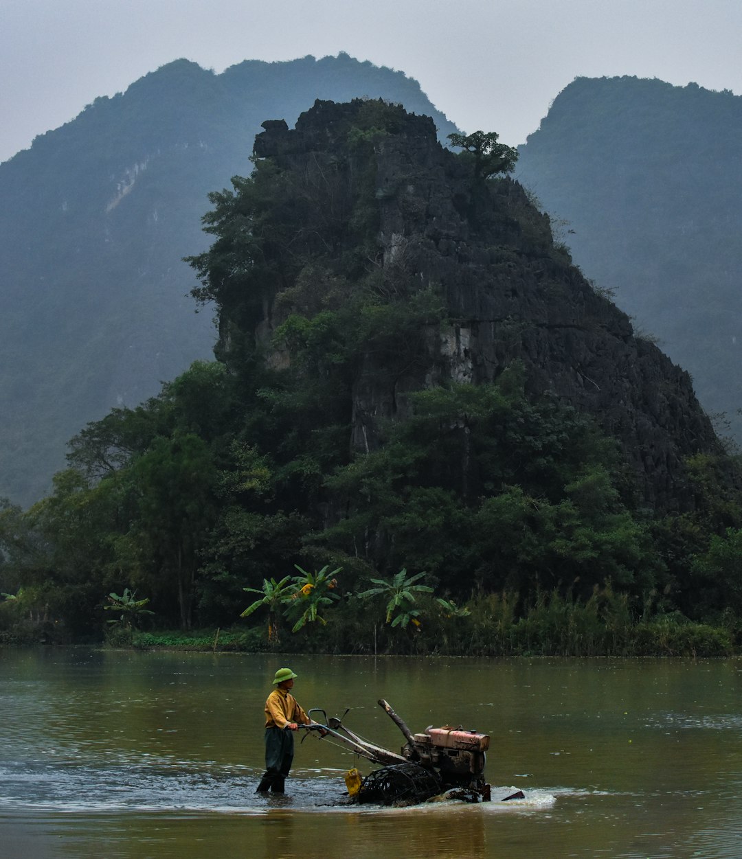 man in yellow shirt riding boat on lake during daytime