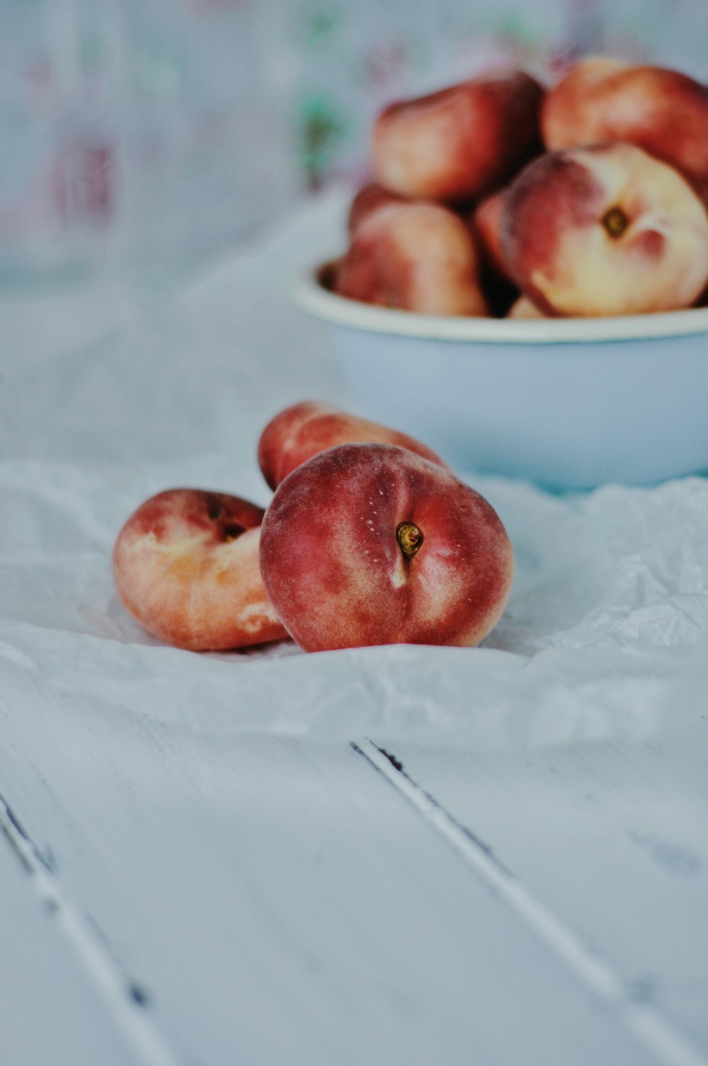 red apples on white ceramic bowl