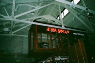A raw, punk-inspired bar setup with metal accents and bold lighting highlighting cocktail prep.