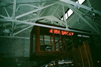 A raw, punk-inspired bar setup with metal accents and bold lighting highlighting cocktail prep.