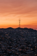 A vibrant sunset cityscape with radio waves symbolizing broadcast reach.