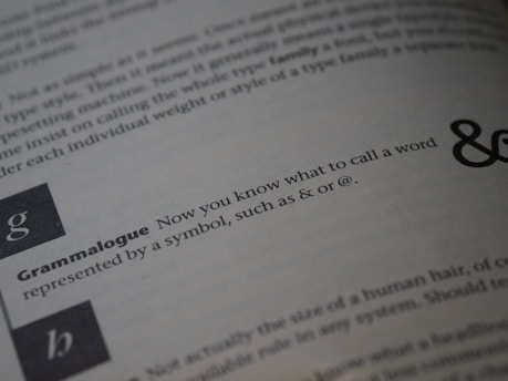 A close-up view of a page from an instructional text, focused on a section with the word 'Grammalogue' in bold, followed by a sentence explaining the term. The background shows blurred text with variations in typography size and boldness.